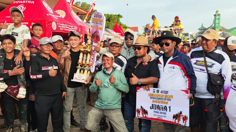SOLID. Haji Fathor Rosi yang familiar disapa Haji Rosi bersama timnya berpose dengan piala juara pertama Kerapan Sapi Kapolres Sumenep Cup 2025 di Lapangan Kerapan Sapi Sumenep